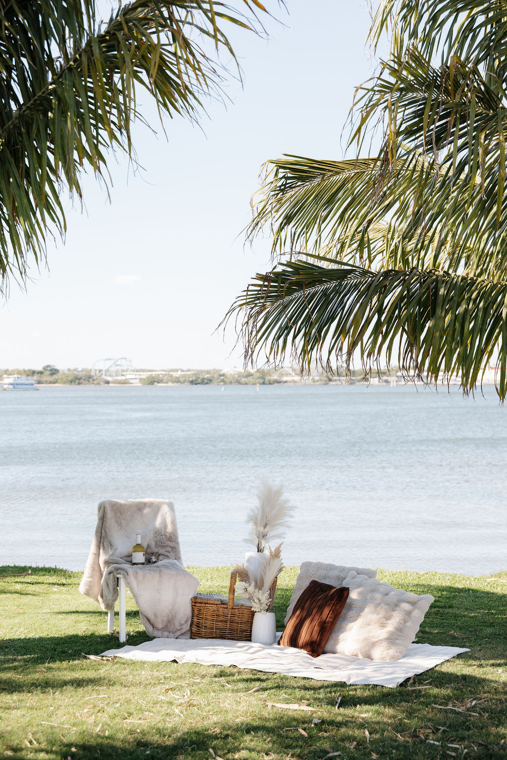 Romantic waterside picnic proposal setup with palm trees on the Gold Coast
