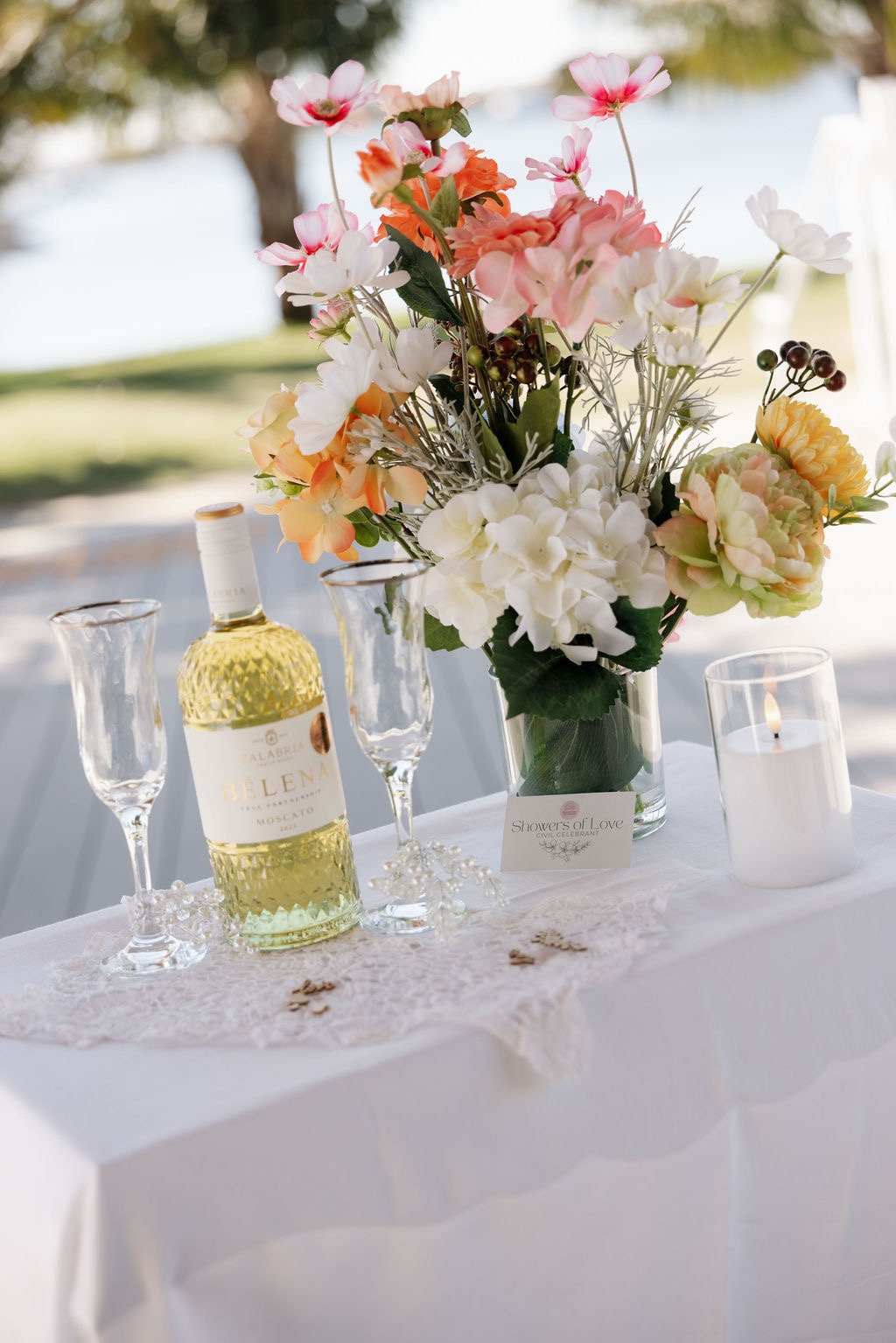 Elegant elopement table setting with flowers, wine and candles by Showers of Love